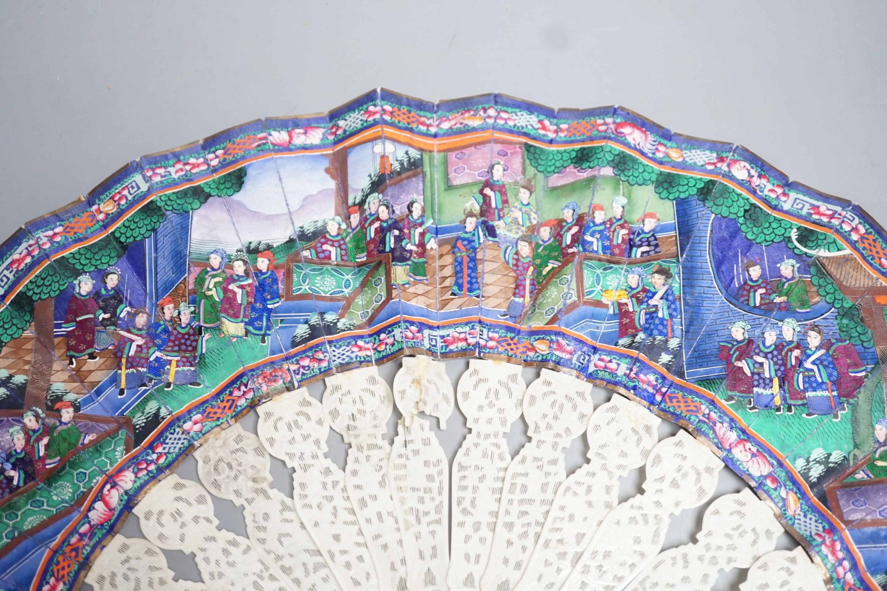 A 19th century Chinese export pierced ivory and painted paper leaf fan, in box. Fan 28cm long